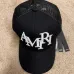 1Amiri Staggered Logo Trucker Hat Black #A37246